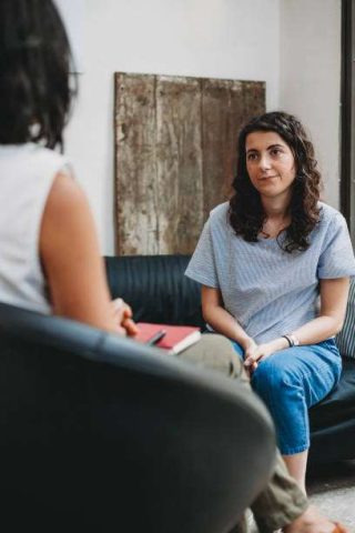Psychotherapy session, woman talking to his psychologist in the studio