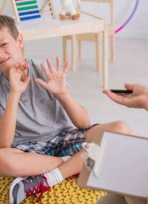 Little stubborn boy with behavioral problems refusing to work with female child therapist